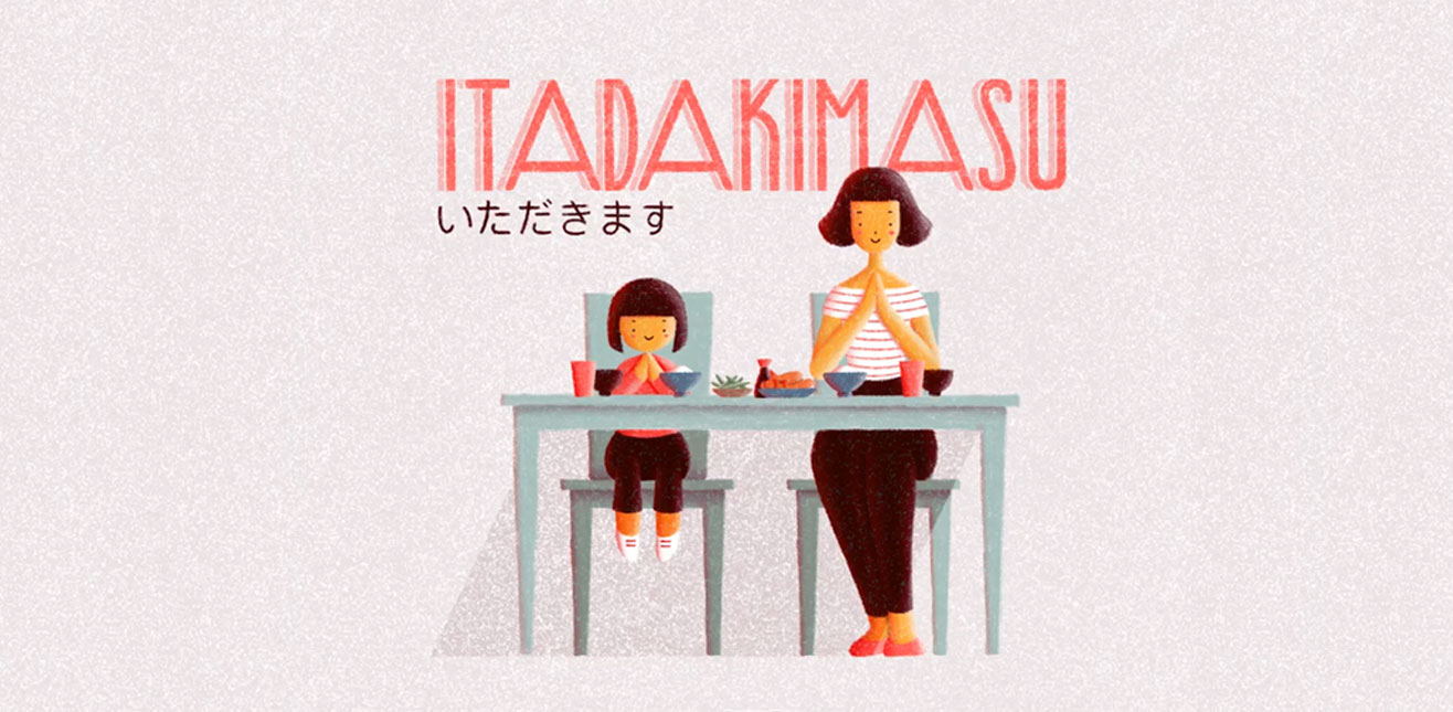 Texto: Itadakimasu (いただきます) em fonte rosa. Abaixo do texto está uma ilustração de uma criança e uma mulher, sentadas à mesa fazendo gesto de prece, com as mãos unidas, diante dos pratos de comida.